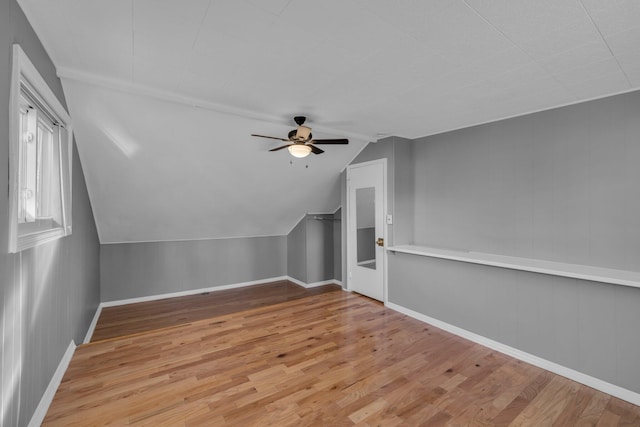 additional living space featuring ceiling fan, lofted ceiling, and light wood-type flooring