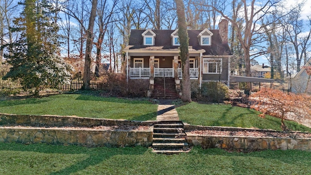 cape cod house featuring a front lawn and covered porch