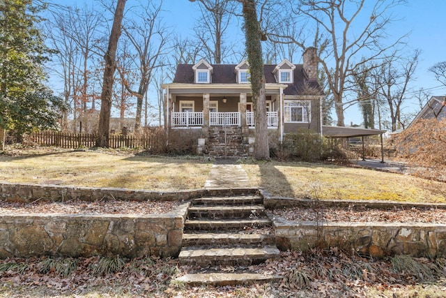 cape cod-style house with a front yard and covered porch