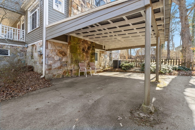 view of patio / terrace featuring central AC unit and a carport