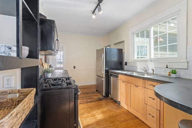 kitchen featuring tasteful backsplash, ornamental molding, stainless steel appliances, light brown cabinets, and light hardwood / wood-style flooring