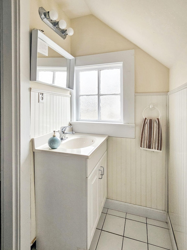 bathroom featuring vanity, lofted ceiling, and tile patterned floors