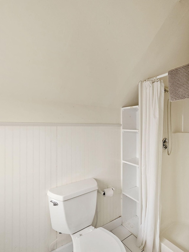 bathroom featuring toilet and a shower with curtain