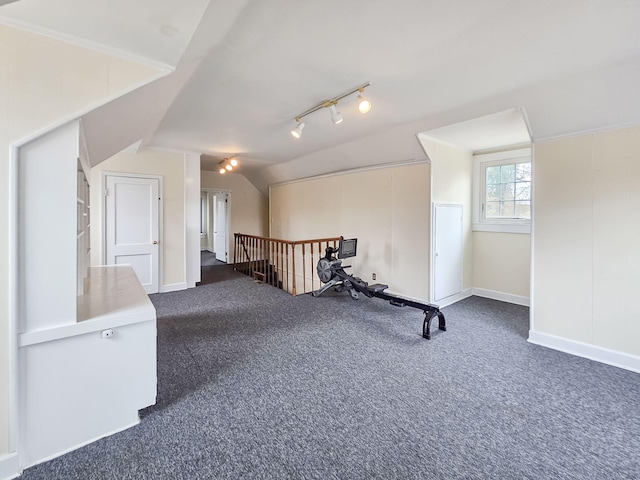 bonus room with vaulted ceiling and dark carpet