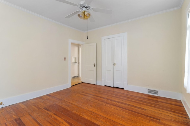 unfurnished room with crown molding, ceiling fan, and light wood-type flooring