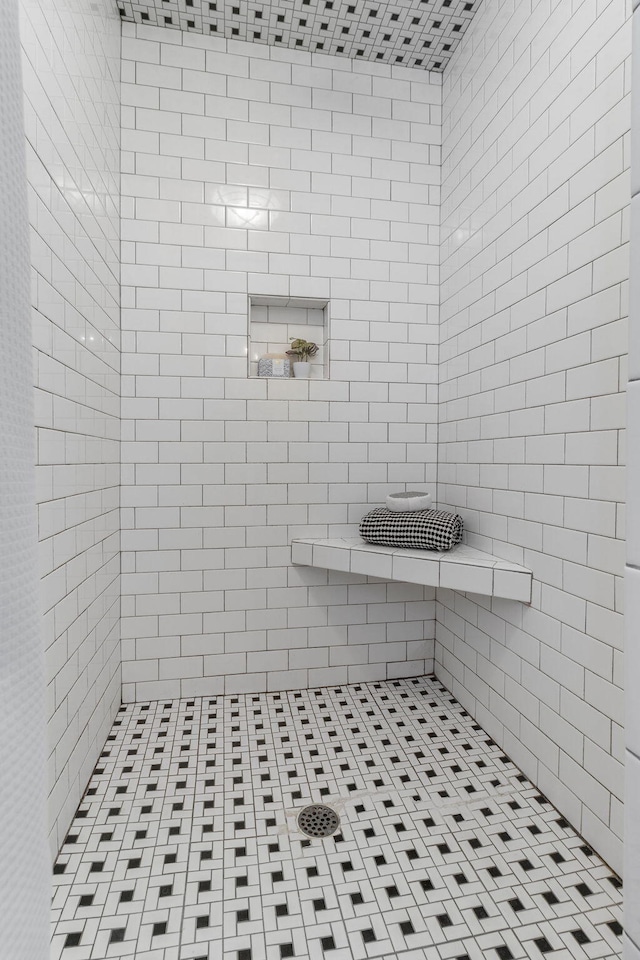 bathroom with tiled shower