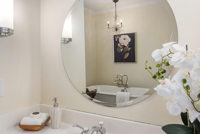 bathroom featuring an inviting chandelier, a bath, and ornamental molding