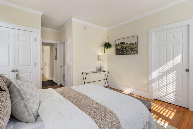 bedroom featuring ornamental molding, wood-type flooring, and a closet