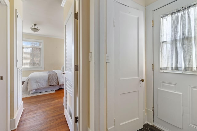 corridor featuring crown molding and hardwood / wood-style floors