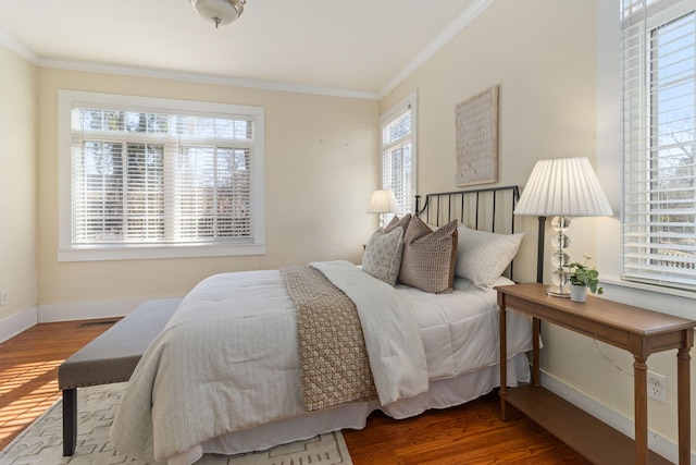 bedroom with hardwood / wood-style floors and ornamental molding