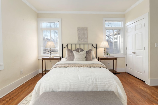 bedroom with crown molding and hardwood / wood-style floors