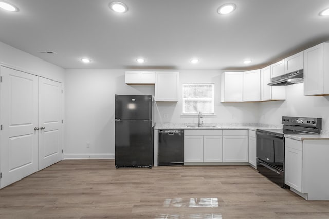 kitchen featuring white cabinetry, light hardwood / wood-style floors, sink, and black appliances