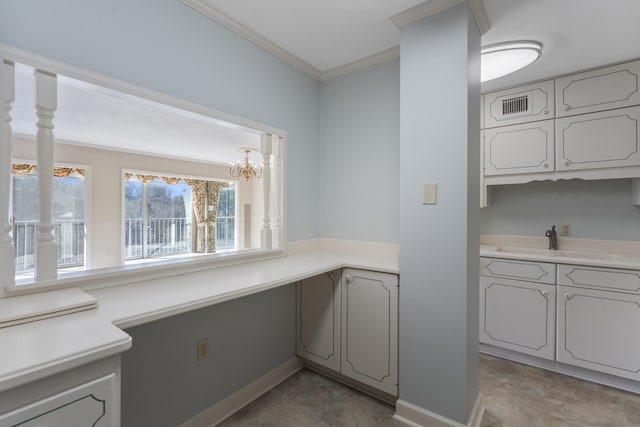 kitchen featuring sink and crown molding