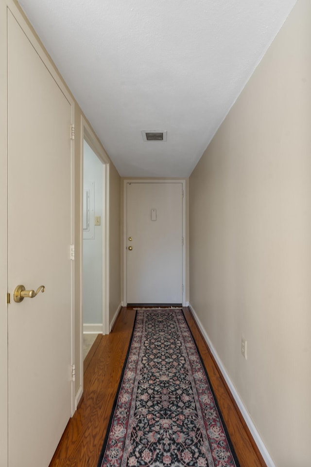 corridor featuring wood-type flooring