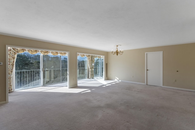 unfurnished room featuring light colored carpet, ornamental molding, and an inviting chandelier