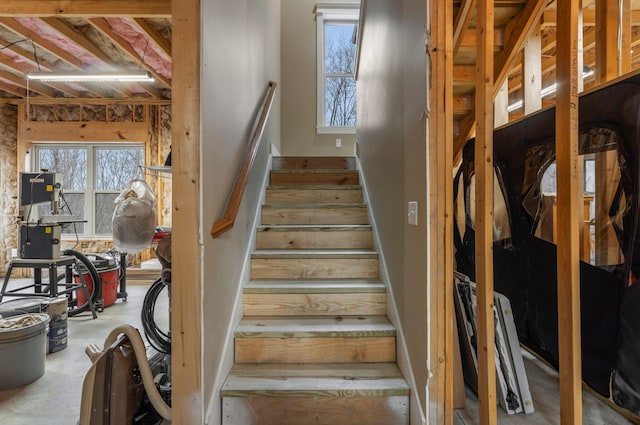 staircase with concrete flooring