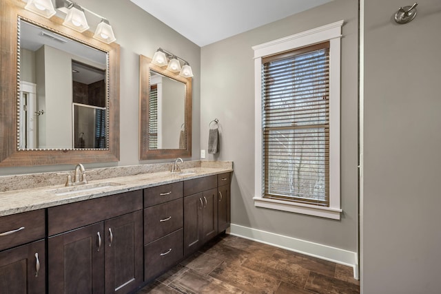 bathroom featuring plenty of natural light, an enclosed shower, and vanity