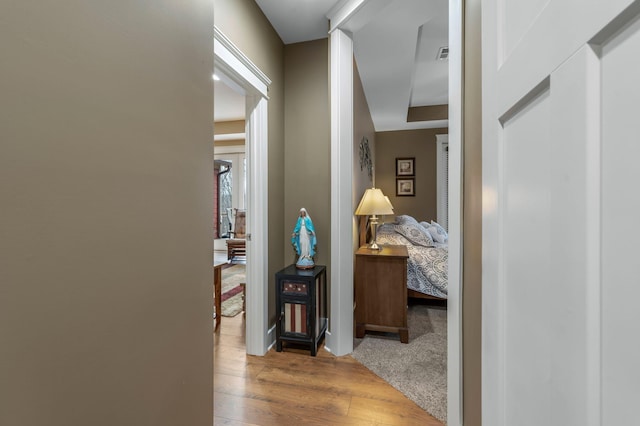 hallway with hardwood / wood-style floors