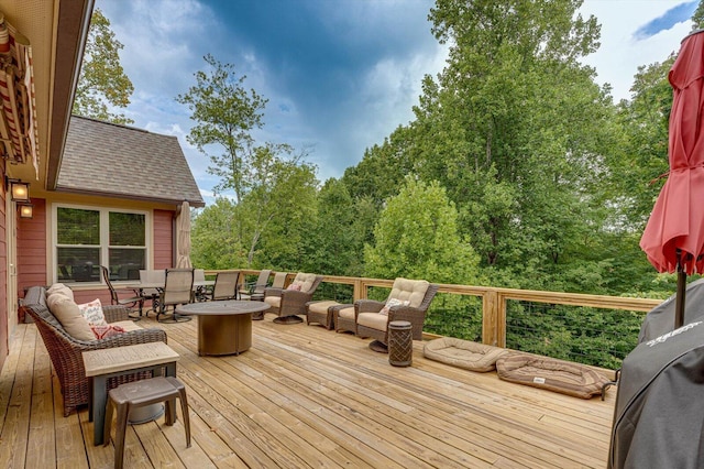 wooden terrace featuring a fire pit