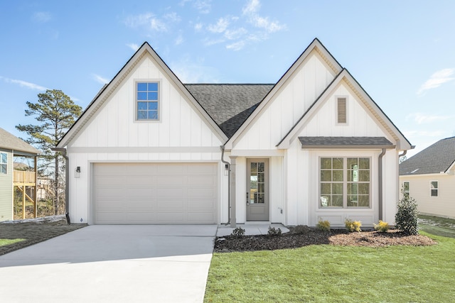 view of front of home with a garage and a front yard