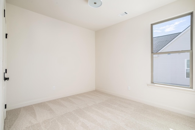 empty room featuring light colored carpet