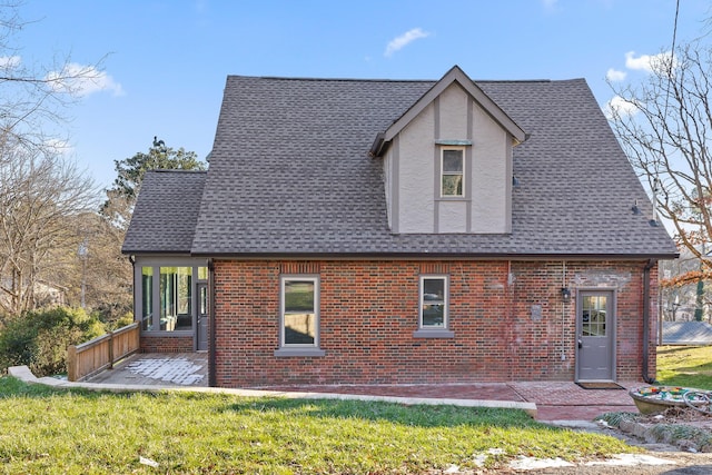 rear view of property with a lawn