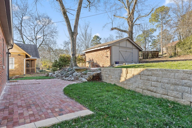 view of yard with a storage shed and a patio