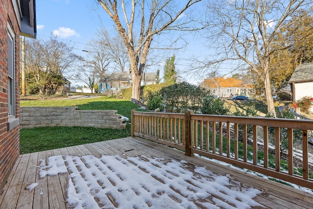 wooden terrace featuring a yard