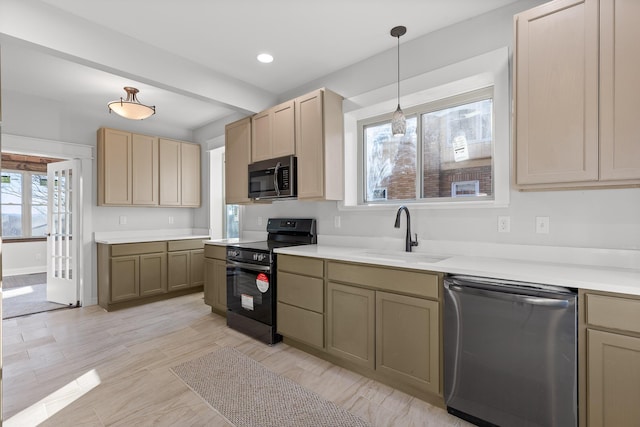 kitchen featuring sink, hanging light fixtures, light brown cabinets, and stainless steel appliances