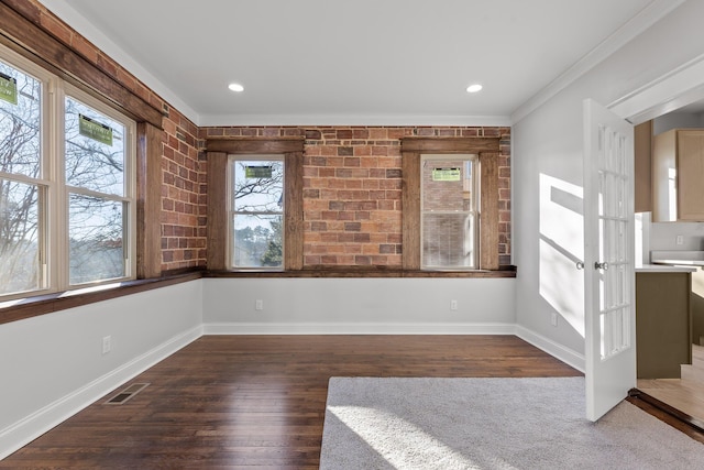 unfurnished dining area with dark hardwood / wood-style flooring and crown molding