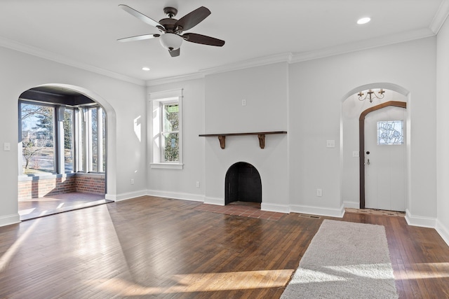 unfurnished living room featuring dark wood-type flooring, ceiling fan, and crown molding