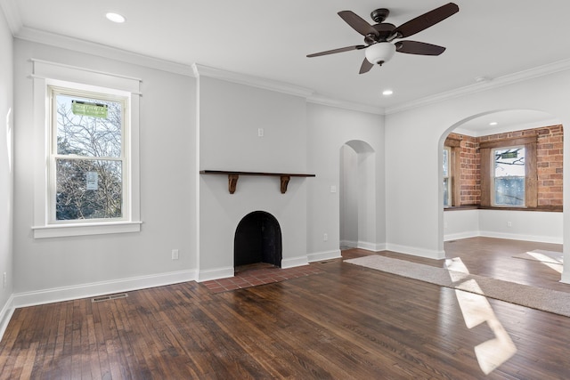 unfurnished living room with ceiling fan, ornamental molding, a fireplace, and dark hardwood / wood-style flooring