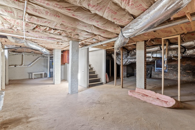 basement featuring brick wall