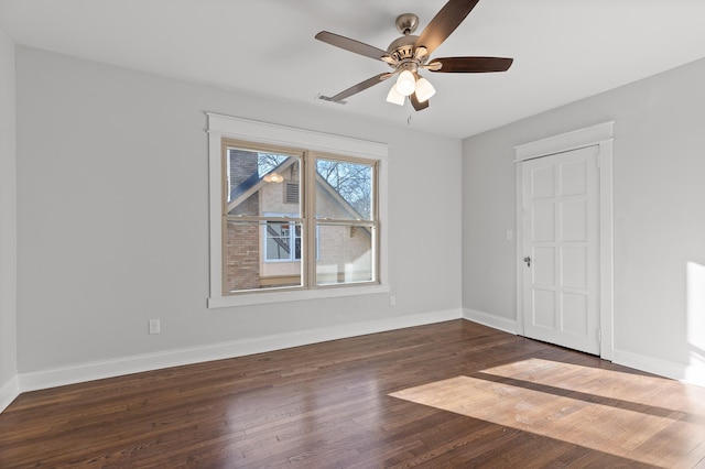 empty room featuring ceiling fan and dark hardwood / wood-style flooring