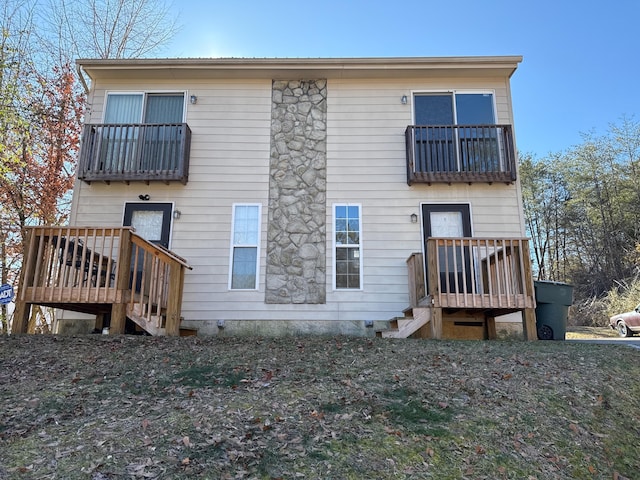 back of house featuring a balcony