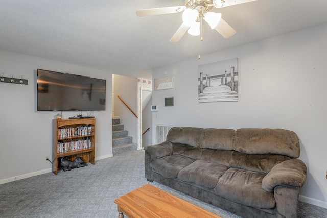 carpeted living room with ceiling fan