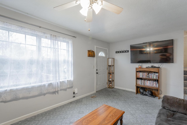 carpeted living room with ceiling fan