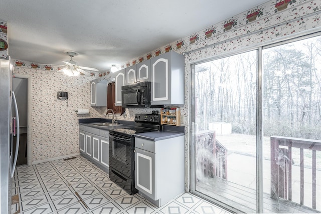 kitchen with ceiling fan, sink, and black appliances