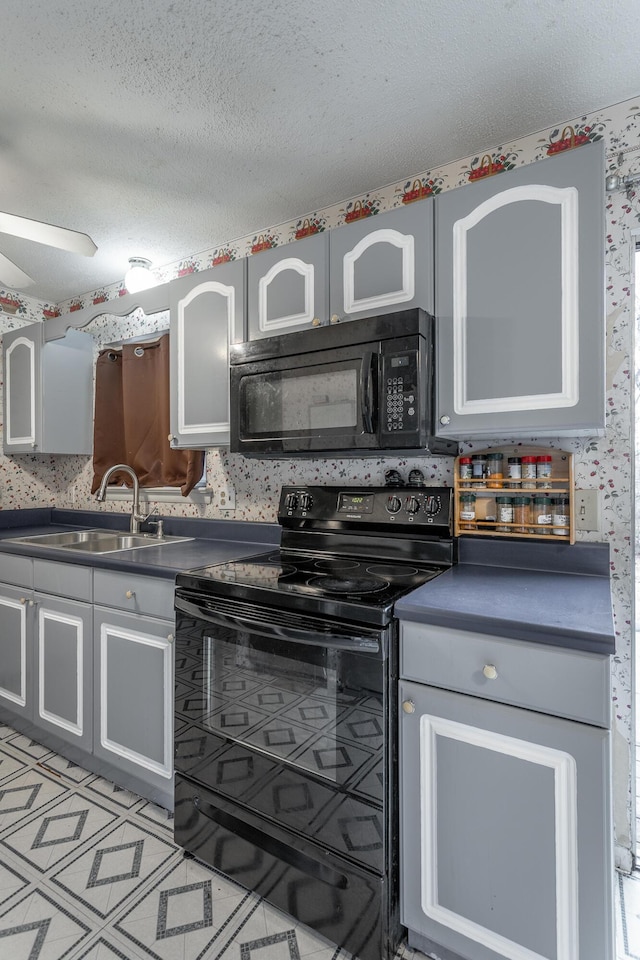 kitchen with gray cabinetry, sink, a textured ceiling, and black appliances