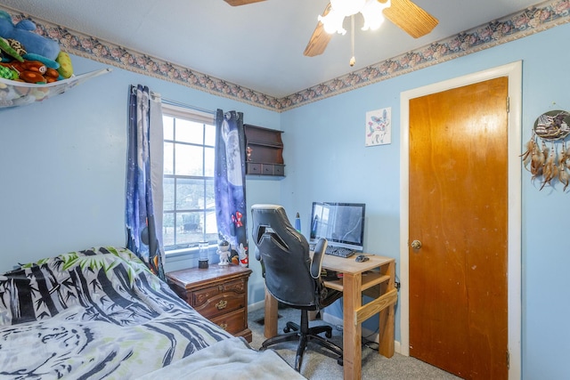 bedroom featuring ceiling fan and carpet