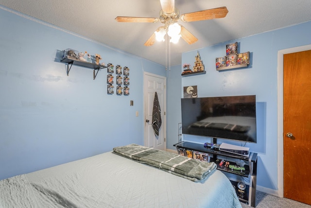 carpeted bedroom with a textured ceiling and ceiling fan