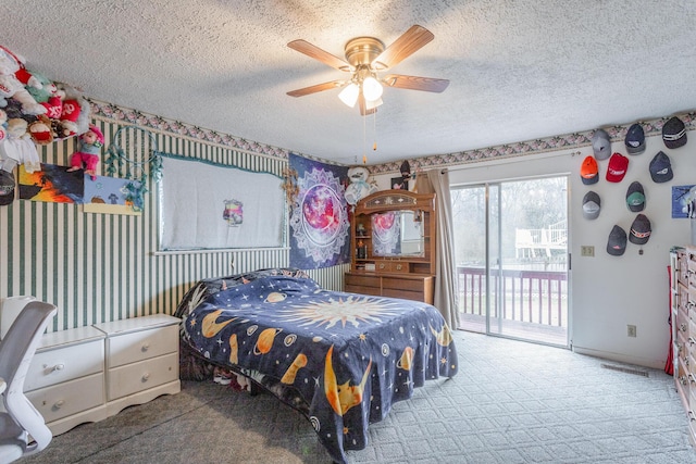 carpeted bedroom featuring a textured ceiling, access to exterior, and ceiling fan