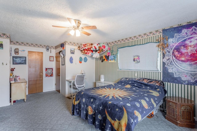 bedroom with ceiling fan, carpet floors, and a textured ceiling