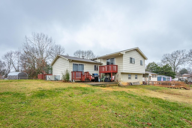 back of property featuring a lawn and a deck