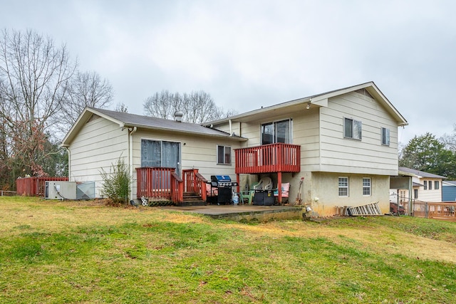 back of property featuring a wooden deck and a yard