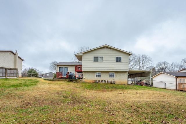 rear view of house featuring a yard