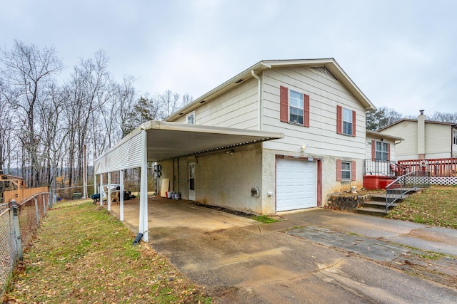 view of side of home featuring a garage and a carport