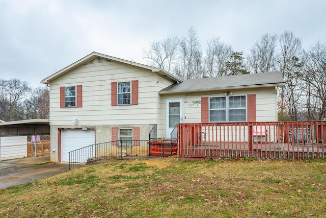 tri-level home featuring a garage, a carport, and a front lawn