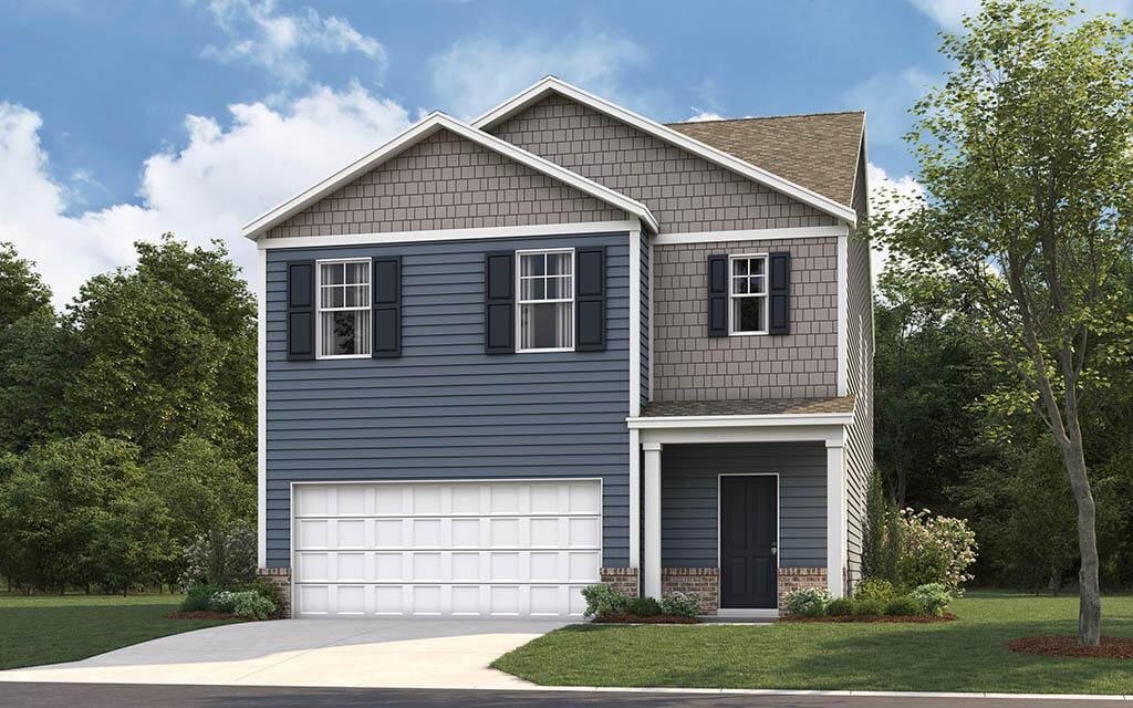 view of front of house with a front yard and a garage