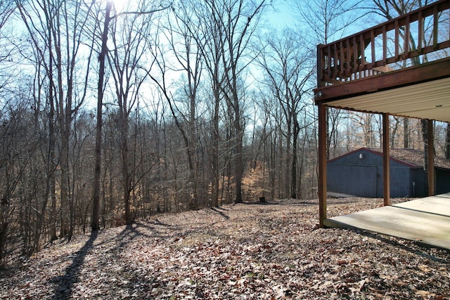 view of yard featuring a storage shed and a deck